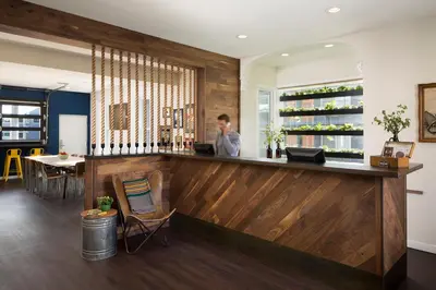 a man standing at a bar in a restaurant at Basecamp Boulder in Boulder