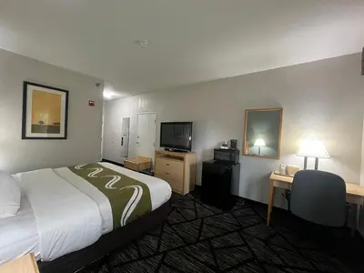 a hotel room with a bed and a television at Quality Inn & Suites Loveland in Loveland