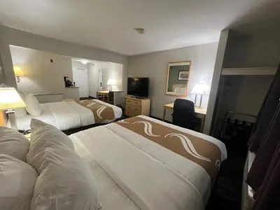 a hotel room with two beds and a television at Quality Inn & Suites Loveland in Loveland