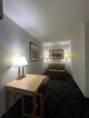 a living room with a table and a couch at Quality Inn & Suites Loveland in Loveland