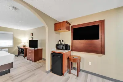a hotel room with a bed and a tv at Comfort Suites Lakewood - Denver in Lakewood