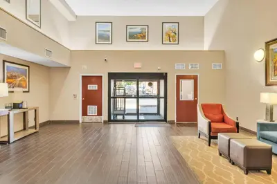 a living room with a couch and a chair at Comfort Suites Lakewood - Denver in Lakewood