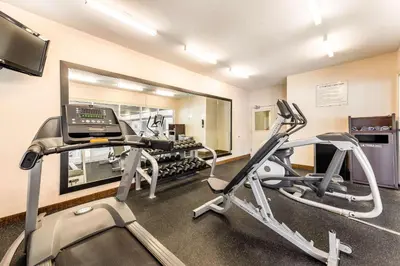 a room with a gym with a treadmill at Quality Inn & Suites University Fort Collins in Fort Collins