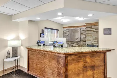 a lobby with a reception desk with two phones at Comfort Inn Denver West Arvada Station in Wheat Ridge