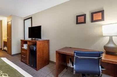 a room with a desk with a computer and a chair at Comfort Inn Denver West Arvada Station in Wheat Ridge