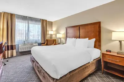 a hotel room with a large bed and a window at Comfort Inn Denver West Arvada Station in Wheat Ridge
