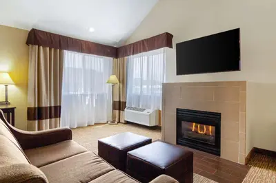 a living room with a couch and a fireplace at Comfort Inn & Suites Greeley in Greeley