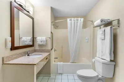 a bathroom with a toilet and a sink and a shower at Comfort Inn & Suites Greeley in Greeley