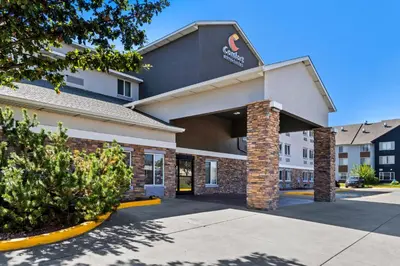 a front view of a hotel with a building at Comfort Inn & Suites Greeley in Greeley