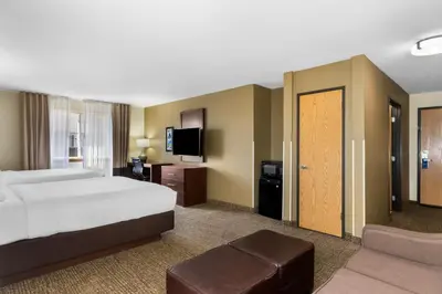 a hotel room with a bed and a tv at Comfort Inn & Suites Greeley in Greeley
