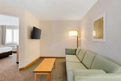 a hotel room with a couch and a table at Quality Inn & Suites Denver Airport - Gateway Park in Aurora