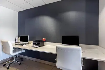 an office with two computers on a desk with two chairs at Quality Inn & Suites Denver Airport - Gateway Park in Aurora