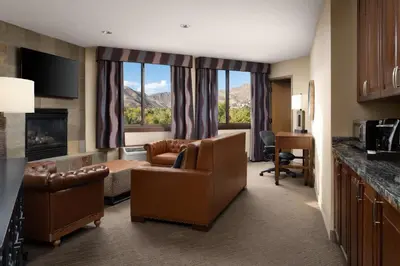 a hotel suite with a living room with a view of the mountains at The Golden Hotel, an Ascend Collection Hotel in Golden