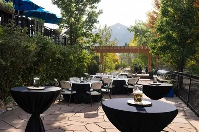 a group of tables and chairs with wine glasses at The Golden Hotel, an Ascend Collection Hotel in Golden
