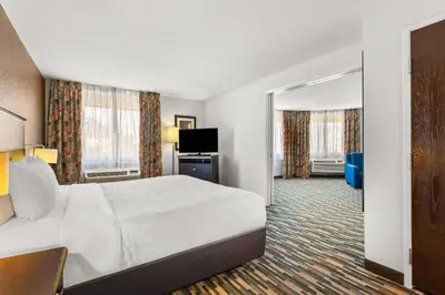 a hotel room with a bed and a television at Quality Inn & Suites Denver International Airport in Denver