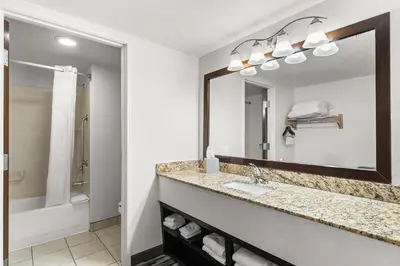 a bathroom with a sink and a mirror at Quality Inn & Suites Denver International Airport in Denver