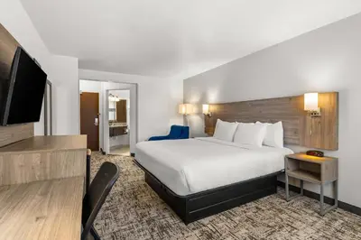 a hotel room with a bed and a flat screen tv at Quality Inn & Suites Denver International Airport in Denver