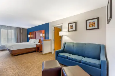 a hotel room with a couch and a bed at Comfort Suites Longmont in Longmont