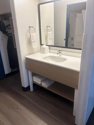 a bathroom with a sink and a mirror at Spark by Hilton Lakewood Denver Southwest in Lakewood