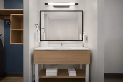 a bathroom with a sink and a mirror at Spark by Hilton Lakewood Denver Southwest in Lakewood