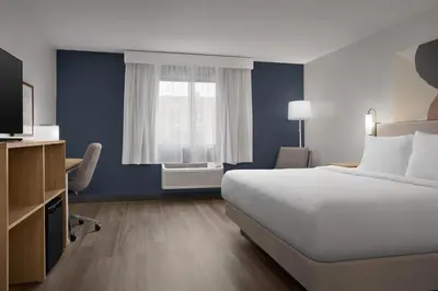 a hotel room with a bed and a window at Spark by Hilton Lakewood Denver Southwest in Lakewood