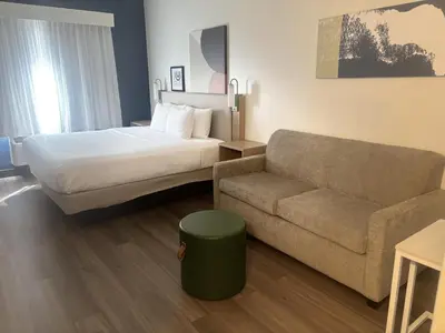 a hotel room with a bed and a couch at Spark by Hilton Lakewood Denver Southwest in Lakewood