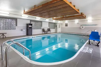 a large pool with blue water in a building at Comfort Suites Fort Collins Near University in Fort Collins