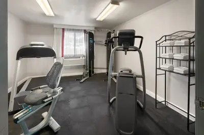 a gym with two tread machines in a room at SYLO Hotel Denver Airport, a Ramada by Wyndham in Aurora