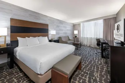 a hotel room with a large bed and a desk at DoubleTree by Hilton Hotel Denver - Aurora in Aurora