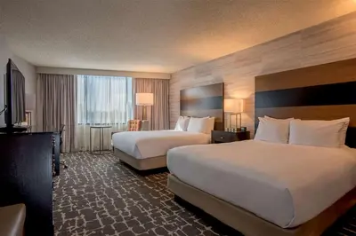 a hotel room with two beds and a large window at DoubleTree by Hilton Hotel Denver - Aurora in Aurora