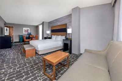 a hotel room with a bed and a couch at DoubleTree by Hilton Hotel Denver - Aurora in Aurora