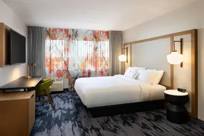 a hotel room with a white bed and a desk at Fairfield Inn & Suites by Marriott Denver Southwest/Lakewood in Lakewood