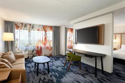 a hotel room with a desk and a bed at Fairfield Inn & Suites by Marriott Denver Southwest/Lakewood in Lakewood