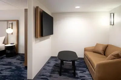 a living room with a couch and a tv at Fairfield Inn & Suites by Marriott Denver Southwest/Lakewood in Lakewood
