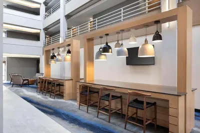 a lobby with a row of chairs and a bar at Fairfield Inn & Suites by Marriott Denver Southwest/Lakewood in Lakewood