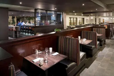 a restaurant with two tables and a bar at DoubleTree by Hilton Denver Tech in Greenwood Village