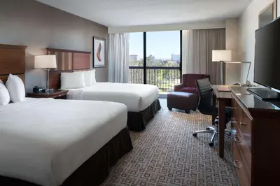 a hotel room with two beds and a desk at DoubleTree by Hilton Denver Tech in Greenwood Village