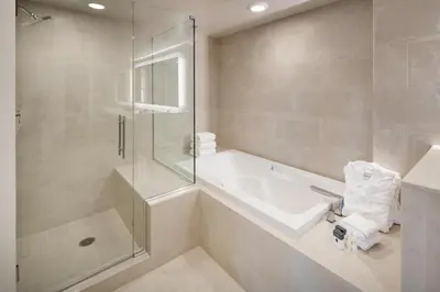a bathroom with a shower and a tub and a sink at DoubleTree by Hilton Denver Tech in Greenwood Village