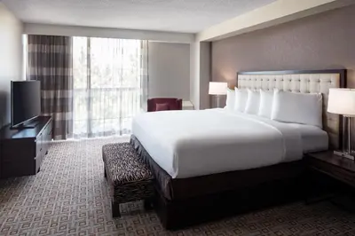 a hotel room with a large bed and a television at DoubleTree by Hilton Denver Tech in Greenwood Village