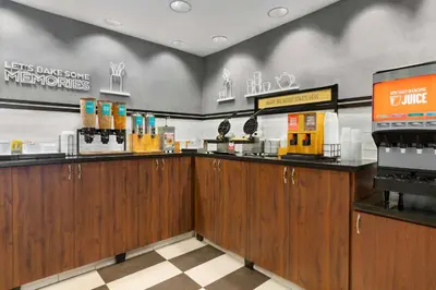 a restaurant with wooden cabinets and a counter top at Hampton Inn Denver-West/Golden in Golden