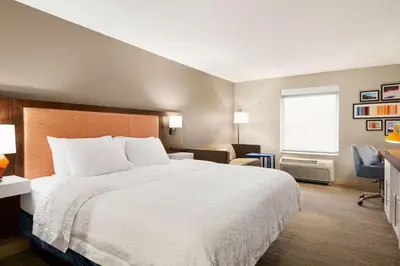 a hotel room with a bed and a desk at Hampton Inn Denver-West/Golden in Golden
