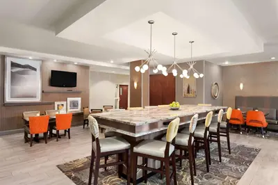 a dining room with a large table and chairs at Hampton Inn & Suites Denver-Cherry Creek in Denver