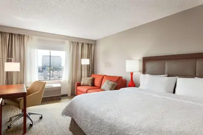 a hotel room with a bed and a desk and a chair at Hampton Inn & Suites Denver-Cherry Creek in Denver