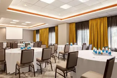 a conference room with white tables and chairs at Hampton Inn & Suites Denver-Cherry Creek in Denver