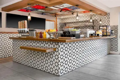 a kitchen with a counter with a counter top at Hilton Garden Inn Denver Airport in Aurora