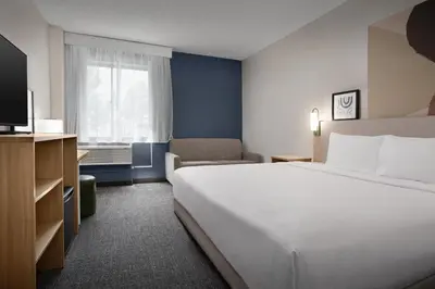a hotel room with a large bed and a television at Spark by Hilton Denver Tech Center Greenwood Village in Greenwood Village