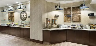 a restaurant with a large clock on the wall at Embassy Suites Denver Tech Center in Centennial