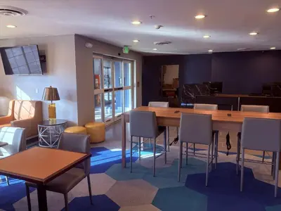 a room with a large wooden table and chairs at Microtel Inn & Suites by Wyndham Denver Airport in Denver