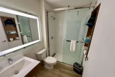 a bathroom with a shower and a toilet and a sink at Microtel Inn & Suites by Wyndham Denver Airport in Denver