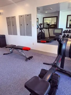 a gym with two exercise bikes and a mirror at Microtel Inn & Suites by Wyndham Denver Airport in Denver